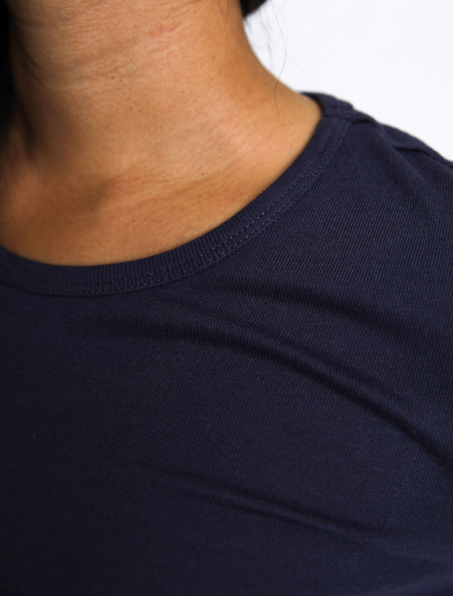 Close up of navy crew neck cotton jersey top from wearwell personal stylist subscription membership made with sustainably sourced materials in ethically run fair trade facility.