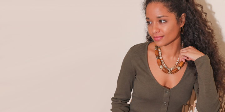 Woman in beaded necklaces and olive button cardigan and hoop earrings | Wearwell ethical and sustainable clothing and accessories